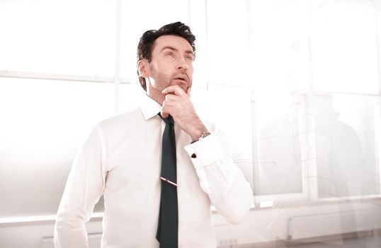 dreaming businessman standing in the office.business concept