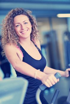 sport, fitness, lifestyle, technology and people concept - smiling woman exercising on treadmill in gym