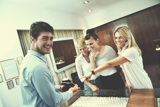 happy girls group  have fun while shopping in jewelry store