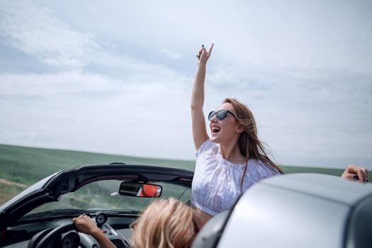 close up. happy young woman traveling in a convertible.photo with copy space