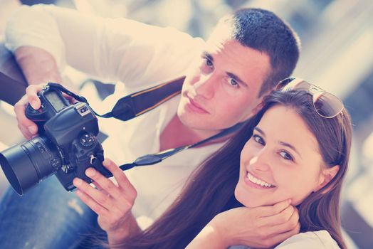 happy young romantic couple looking photos on camera