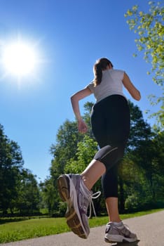 Young beautiful  woman jogging on morning at  park. Woman in sport outdoors health concept