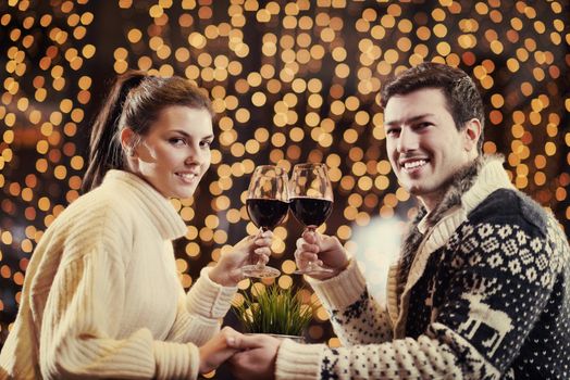 romantic evening date in restaurant  happy young couple with wine glass tea and cake