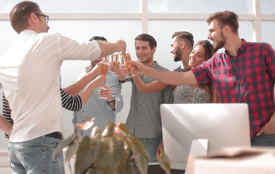 creative business team raising their glasses of champagne.the concept of a startup