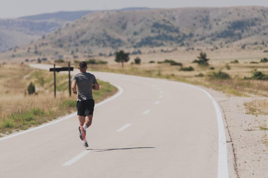 Young man and woman in protective masks running and doing exercises outdoors in the morning. Sport, Active life, Jogging during quarantine. Covid-19 new normal. High quality photo. Selective focus.