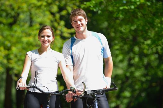 Happy couple riding bicycle outdoors, health lifestyle fun love romance concept