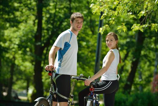 Happy couple ride bicycle outdoors, health lifestyle fun love romance concept