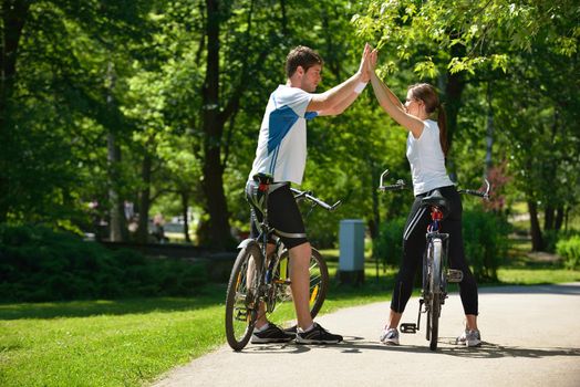 Happy couple ride bicycle outdoors, health lifestyle fun love romance concept