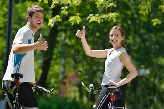 Happy couple riding bicycle outdoors, health lifestyle fun love romance concept