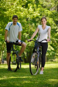 Happy couple ride bicycle outdoors, health lifestyle fun love romance concept