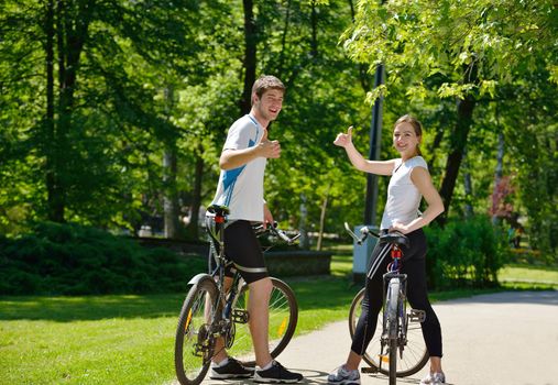 Happy couple riding bicycle outdoors, health lifestyle fun love romance concept