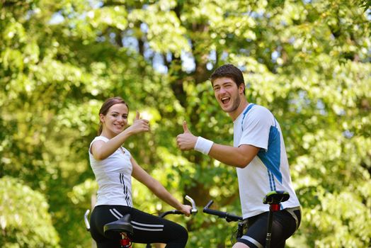 Happy couple ride bicycle outdoors, health lifestyle fun love romance concept