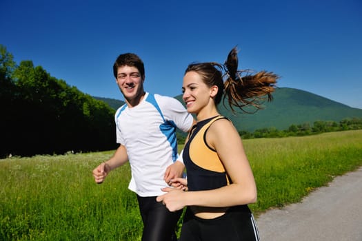 Young couple jogging in park at morning. Health and fitness.