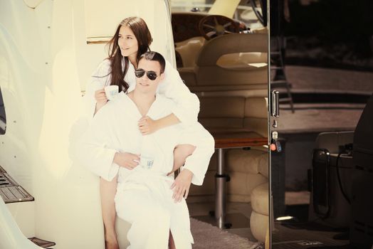 Romantic young couple spending time together and relaxing on yacht