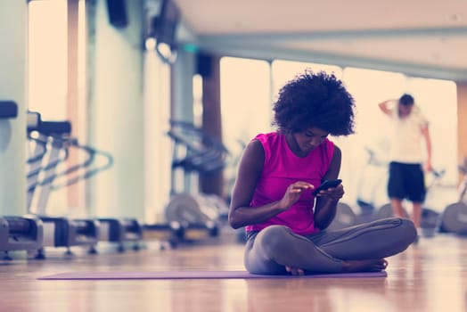 beautiful young african american woman exercise yoga in gym