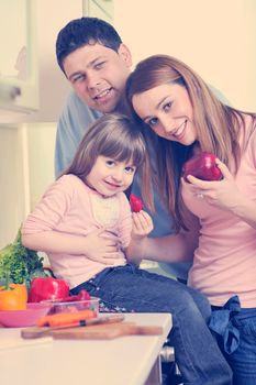 happy young family have lunch time with fresh fruits and vegetable food in bright kitchen 