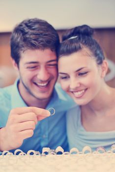 happy young romantic couple in love buy jewelry ring in luxury store