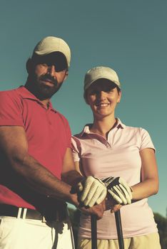 portrait of happy young  couple on golf course