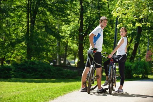 Happy couple ride bicycle outdoors, health lifestyle fun love romance concept