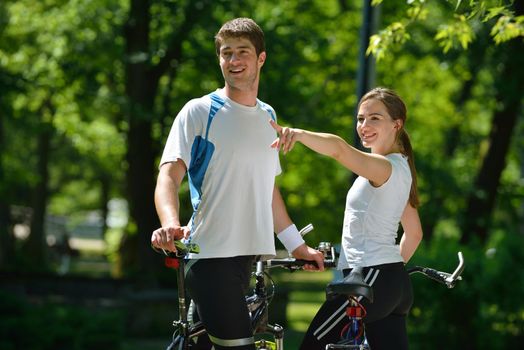 Happy couple ride bicycle outdoors, health lifestyle fun love romance concept