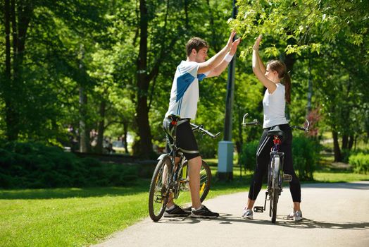 Happy couple ride bicycle outdoors, health lifestyle fun love romance concept