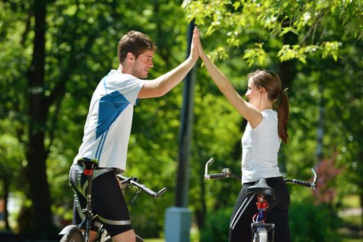 Happy couple ride bicycle outdoors, health lifestyle fun love romance concept