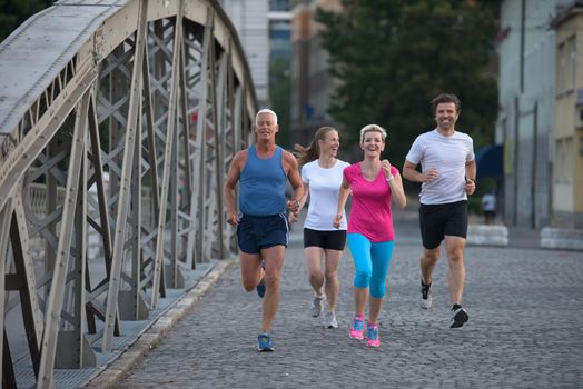 people group jogging  runners team on morning  training workout with sunrise in background