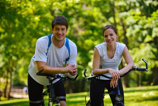 Happy couple ride bicycle outdoors, health lifestyle fun love romance concept