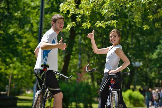 Happy couple ride bicycle outdoors, health lifestyle fun love romance concept