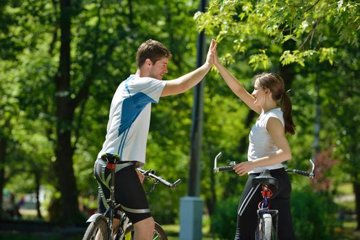 Happy couple ride bicycle outdoors, health lifestyle fun love romance concept