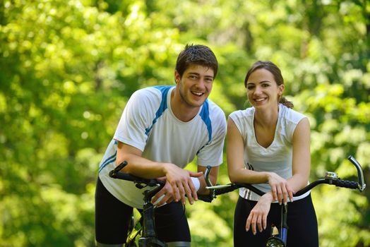 Happy couple ride bicycle outdoors, health lifestyle fun love romance concept