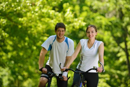 Happy couple ride bicycle outdoors, health lifestyle fun love romance concept