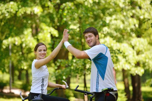 Happy couple ride bicycle outdoors, health lifestyle fun love romance concept