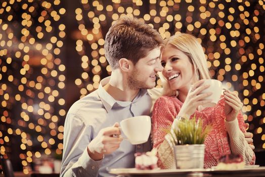 romantic evening date in restaurant  happy young couple with wine glass tea and cake