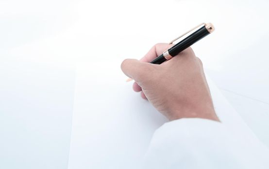 close up.the scientist makes a record on a blank sheet.photo with copy space