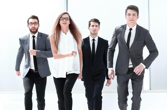 group of business people confidently walking in the office. business concept