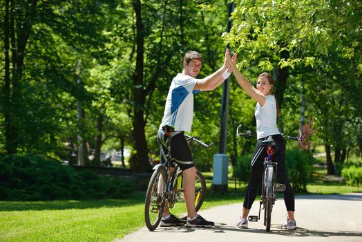 Happy couple ride bicycle outdoors, health lifestyle fun love romance concept