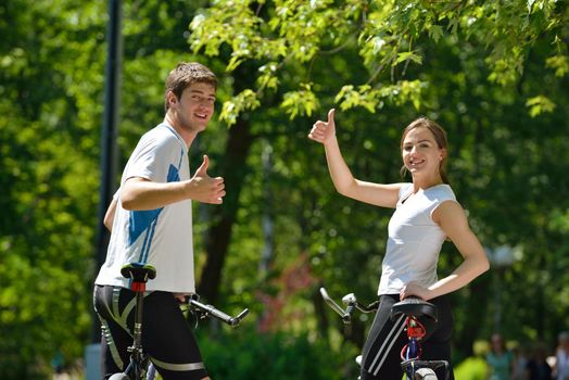 Happy couple ride bicycle outdoors, health lifestyle fun love romance concept