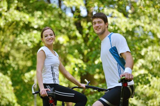 Happy couple ride bicycle outdoors, health lifestyle fun love romance concept