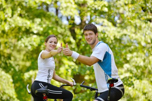 Happy couple riding bicycle outdoors, health lifestyle fun love romance concept