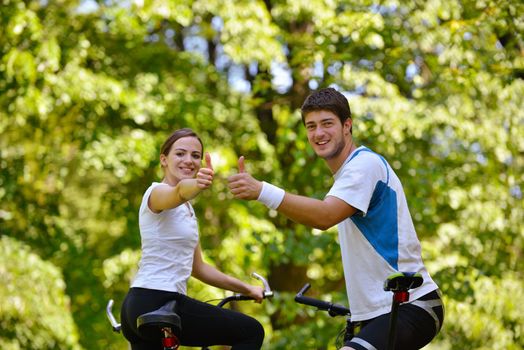 Happy couple ride bicycle outdoors, health lifestyle fun love romance concept