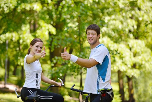 Happy couple riding bicycle outdoors, health lifestyle fun love romance concept