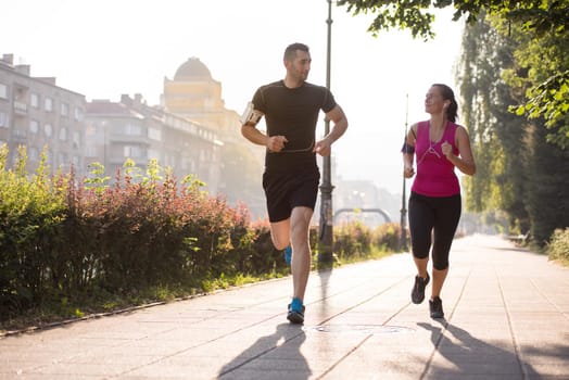 urban sports, healthy young couple jogging  in the city at sunny morning