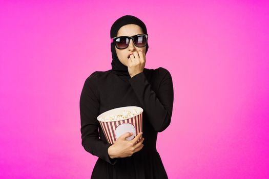 Muslim woman fun popcorn entertainment fashion isolated background. High quality photo