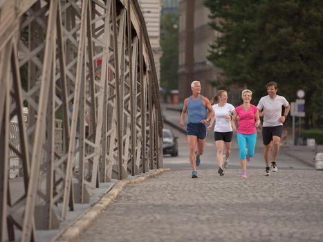 people group jogging  runners team on morning  training workout with sunrise in background