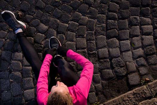 runner   woman warming up and stretching before morning jogging