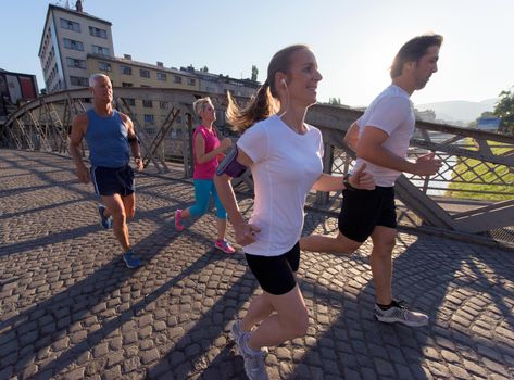 people group jogging  runners team on morning  training workout with sunrise in background