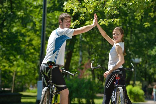 Happy couple ride bicycle outdoors, health lifestyle fun love romance concept