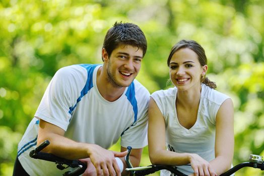 Happy couple riding bicycle outdoors, health lifestyle fun love romance concept