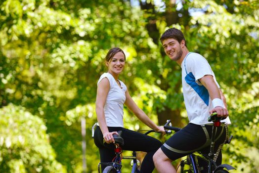 Happy couple ride bicycle outdoors, health lifestyle fun love romance concept